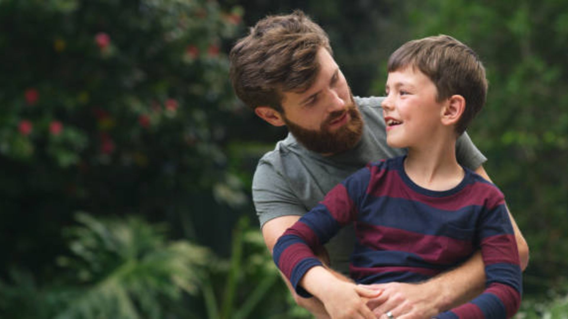 Father guiding his son while teaching values and positive masculinity